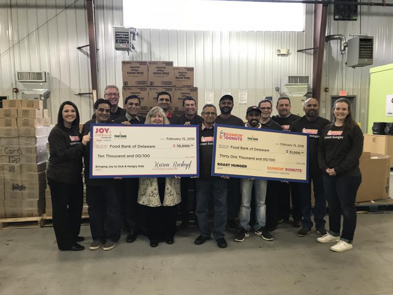 Dunkin’ Donuts employees gathered at the check presentation to Food Bank of Delaware shown are (l-r) Jodie Himelright, Nick Patel, Rick Martson, Raj Patel, Food Bank of Delaware President and CEO Patricia Beebe, Piyush Patel, Teague Higgins, Bhupen Mandal, Jiten Patel, Kunjan Patel, Chuck Kaighn, Bill DePrinzio, Pradip Saha and Jessica Weissman. SUBMITTED PHOTO